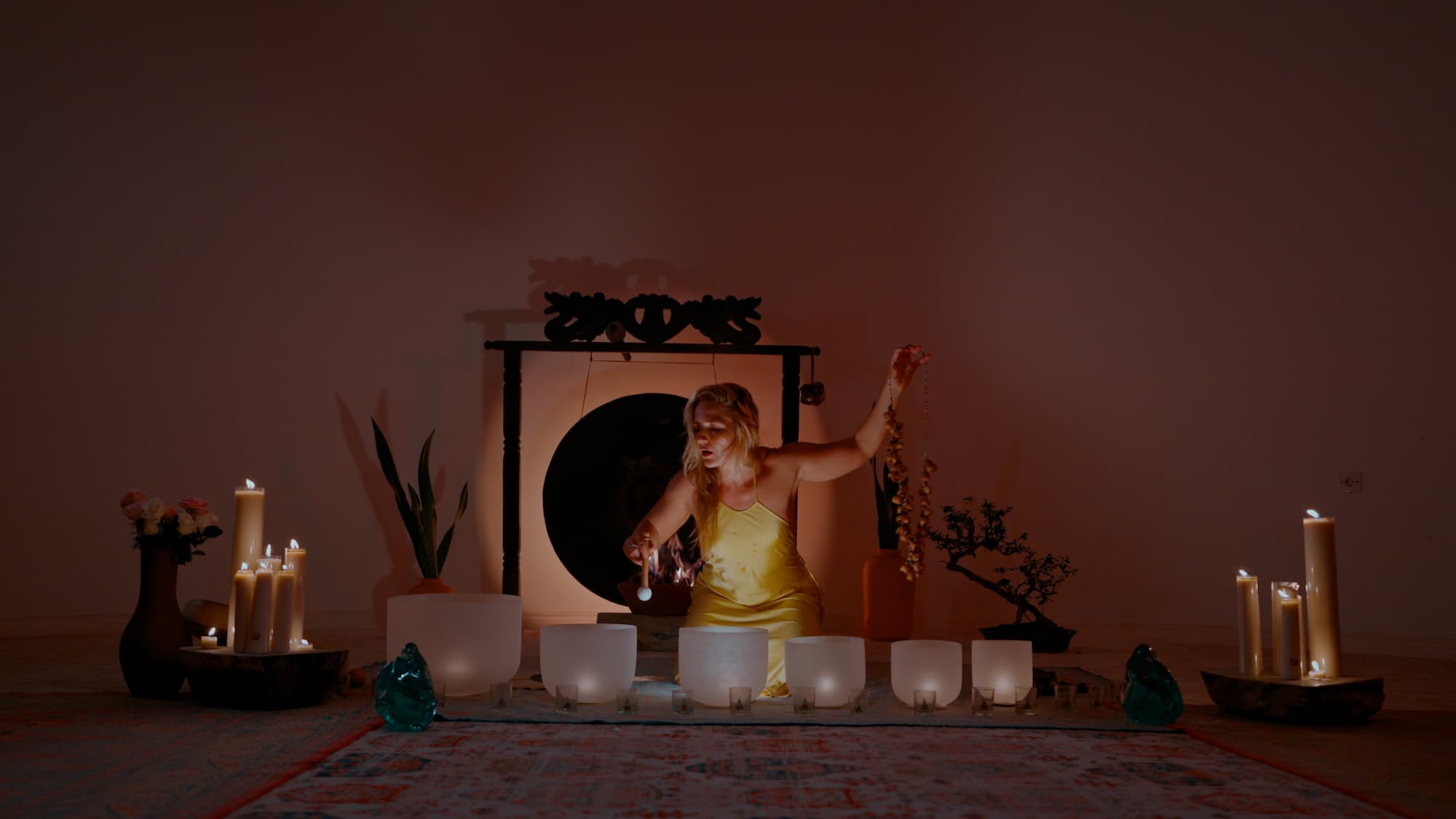 Camila Rivera with arms open, white dress, golden fabric in the light